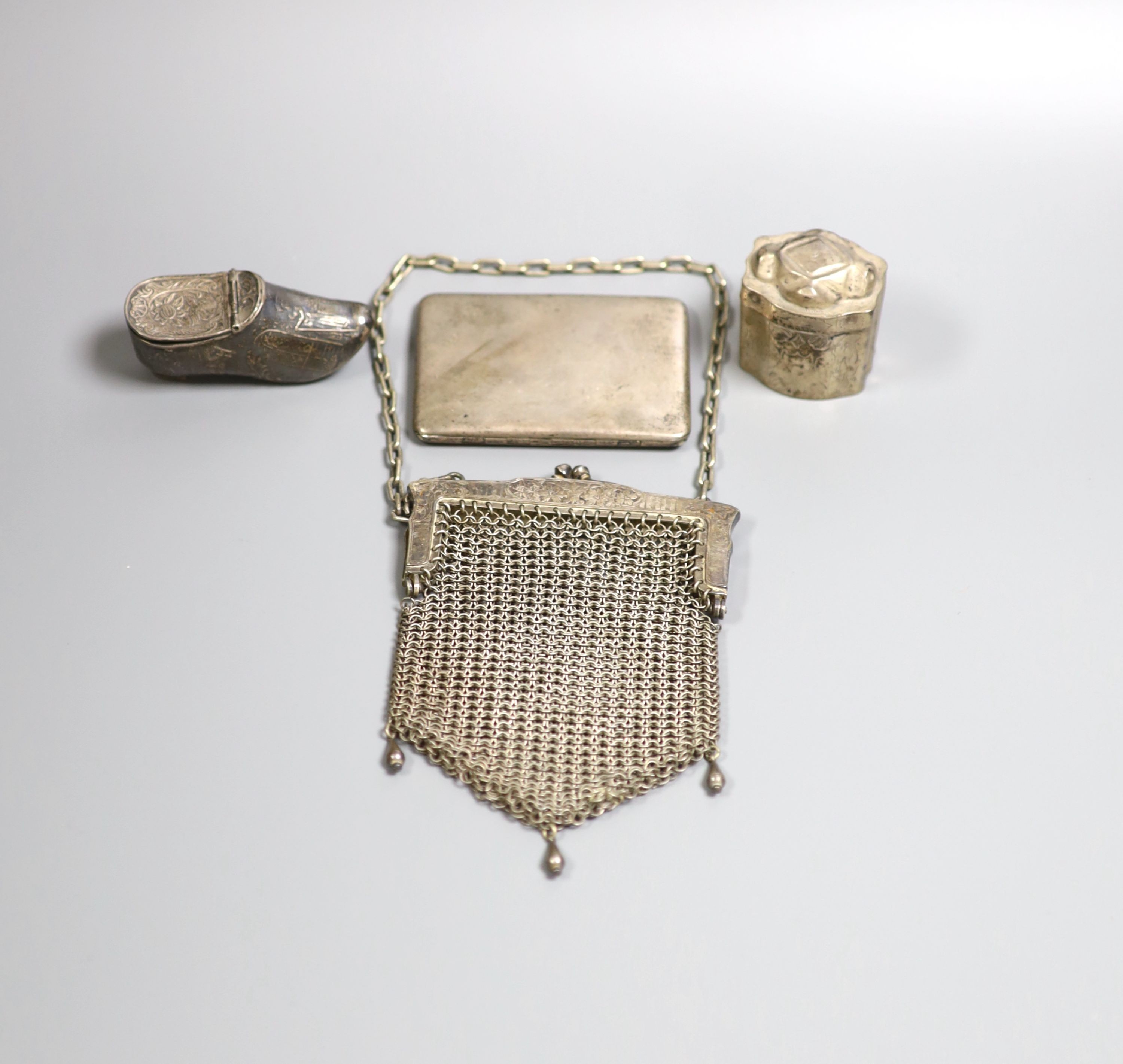 A late Victorian silver shoe vinaigrette, import marks for Sheffield, 1896, 7cm, one other continental white meta box, a silver cigarette case and a mesh evening bag.